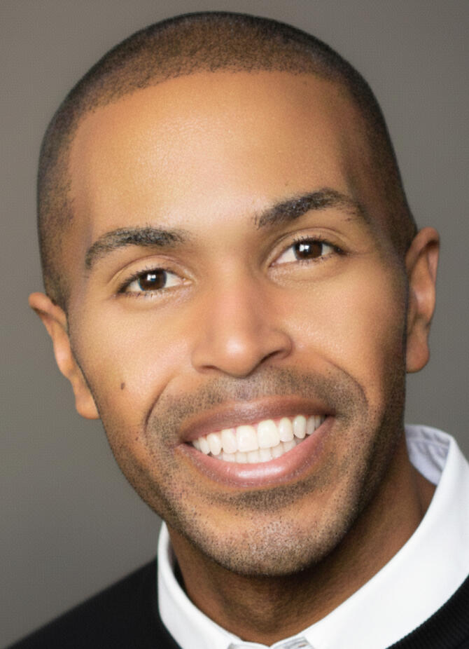 Dion Baez, Global Platform Architect and VP of Community at SoundCloud, posing in professional executive attire.